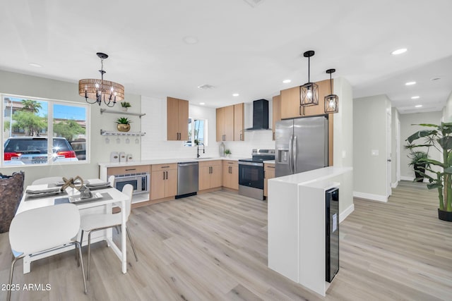 5236 S 19th Ave, Phoenix, AZ 85041 - kitchen with stainless steel appliances, wall chimney exhaust hood, light wood-style floors, light brown cabinets, and recessed lighting