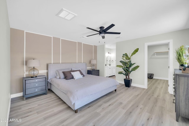 5236 S 19th Ave, Phoenix, AZ 85041 - bedroom featuring light wood-style flooring, a walk in closet, baseboards, and a ceiling fan
