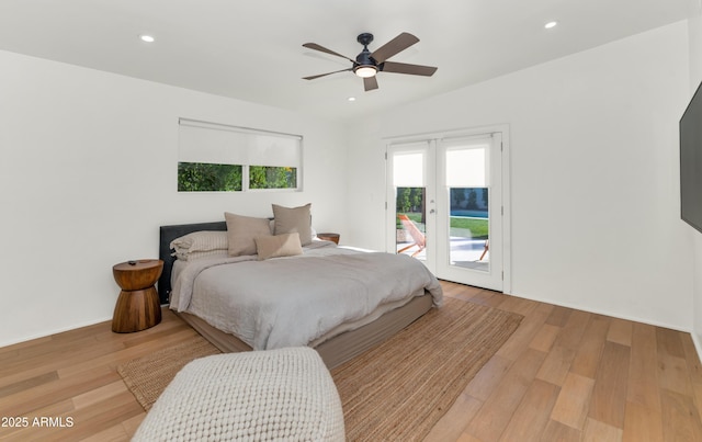 bedroom featuring access to exterior, recessed lighting, lofted ceiling, and wood finished floors