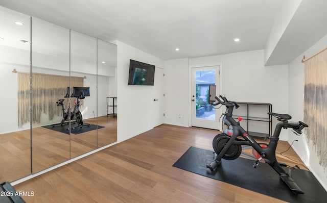 exercise room featuring recessed lighting and wood finished floors