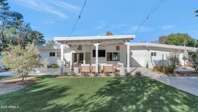 view of front of house featuring a patio, stucco siding, a front lawn, and an outdoor living space