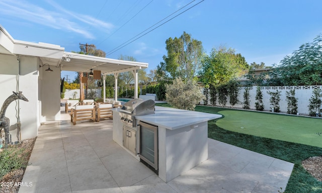 view of patio / terrace featuring grilling area, an outdoor kitchen, fence private yard, and outdoor lounge area