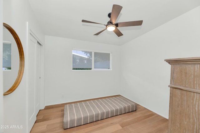 unfurnished room with a ceiling fan, wood finished floors, and baseboards