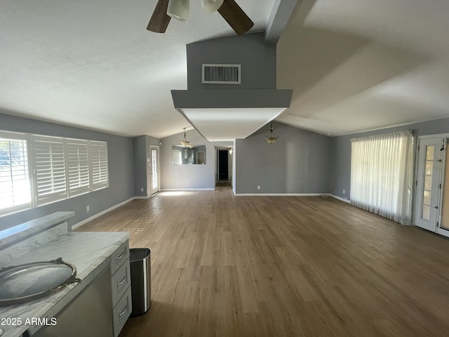 unfurnished living room featuring ceiling fan, lofted ceiling, and hardwood / wood-style floors