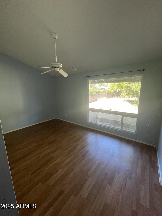 unfurnished room featuring dark hardwood / wood-style floors and ceiling fan