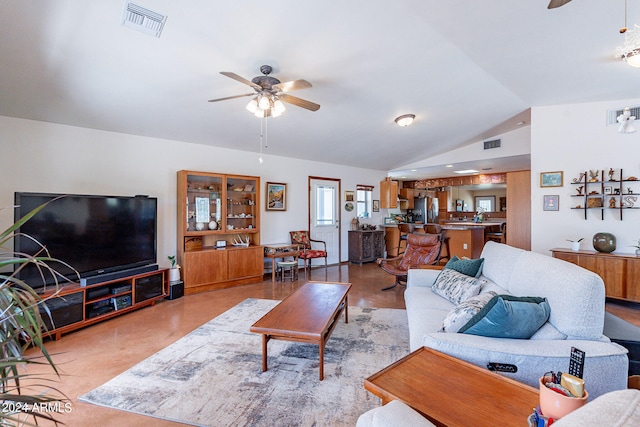 living room featuring ceiling fan and lofted ceiling