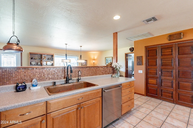 kitchen with decorative light fixtures, sink, tasteful backsplash, and dishwasher