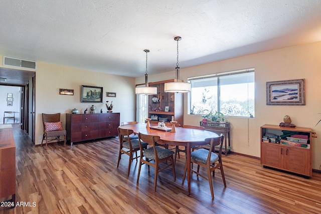 dining area featuring dark wood-type flooring