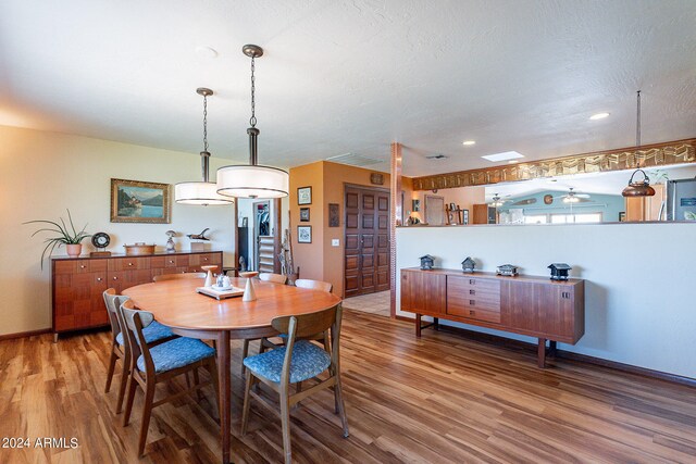 dining area featuring ceiling fan and hardwood / wood-style floors