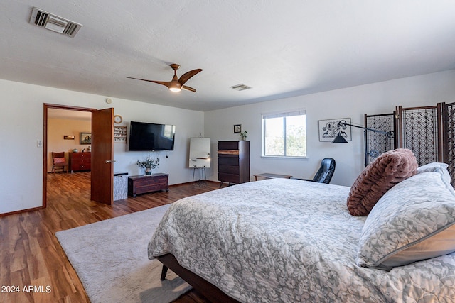 bedroom featuring ceiling fan and dark hardwood / wood-style floors