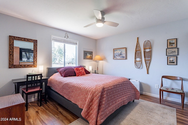 bedroom featuring dark hardwood / wood-style flooring and ceiling fan