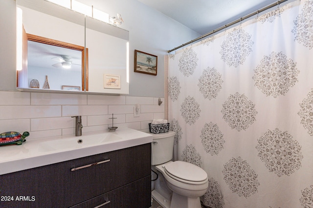 bathroom with tasteful backsplash, toilet, vanity, ceiling fan, and tile walls