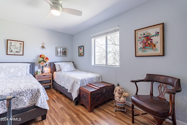 bedroom with light hardwood / wood-style floors and ceiling fan