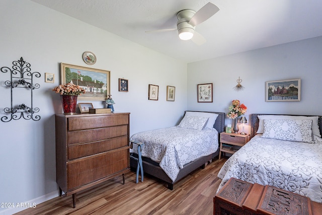 bedroom with ceiling fan and wood-type flooring