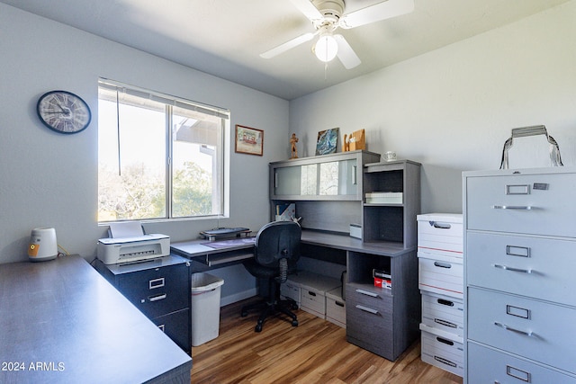 home office featuring ceiling fan and light hardwood / wood-style flooring