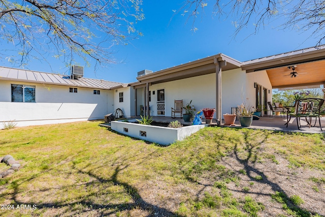 back of property featuring ceiling fan, central air condition unit, a yard, and a patio area