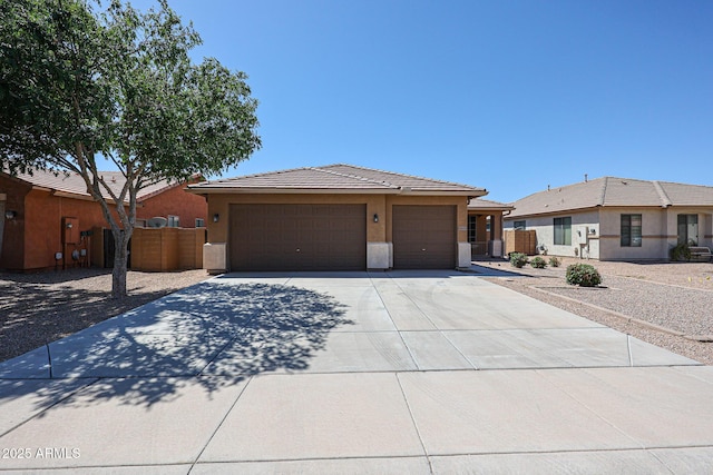 45633 W Mountain View Rd, Maricopa, AZ 85139 - view of front facade featuring fence, stucco siding, an attached garage, driveway, and a tile roof