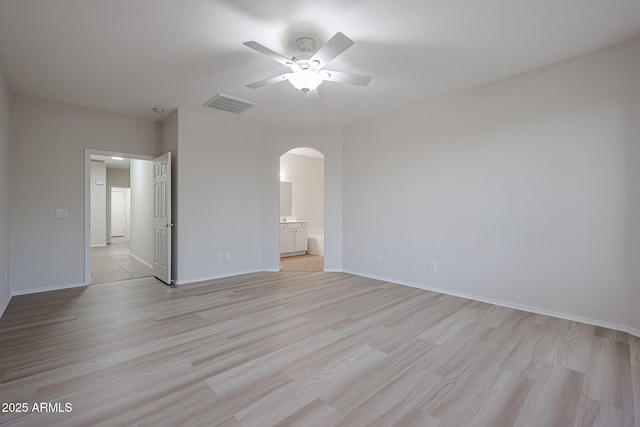 45633 W Mountain View Rd, Maricopa, AZ 85139 - unfurnished bedroom featuring arched walkways, ensuite bathroom, light wood-type flooring, and visible vents