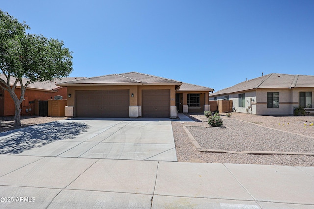 45633 W Mountain View Rd, Maricopa, AZ 85139 - view of front facade featuring a garage, fence, stucco siding, a tiled roof, and driveway
