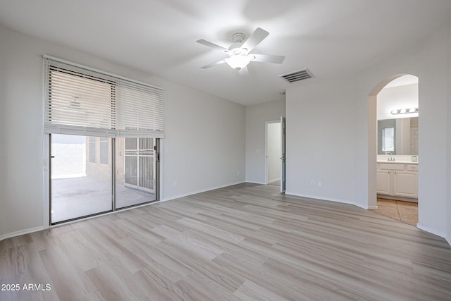 45633 W Mountain View Rd, Maricopa, AZ 85139 - spare room with arched walkways, a ceiling fan, visible vents, and light wood-style flooring