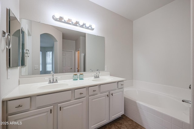 45633 W Mountain View Rd, Maricopa, AZ 85139 - bathroom featuring a sink, a garden tub, and double vanity