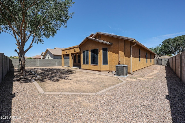 45633 W Mountain View Rd, Maricopa, AZ 85139 - back of property featuring stucco siding, a fenced backyard, and central AC