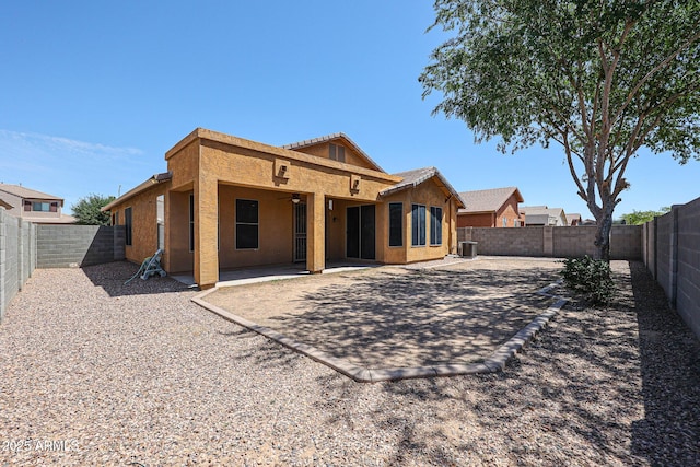 45633 W Mountain View Rd, Maricopa, AZ 85139 - rear view of house with a fenced backyard, ceiling fan, cooling unit, and stucco siding