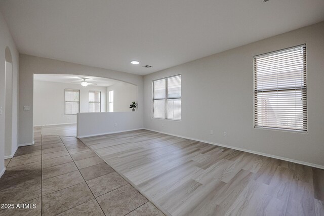 45633 W Mountain View Rd, Maricopa, AZ 85139 - spare room featuring baseboards, a ceiling fan, wood finished floors, and visible vents