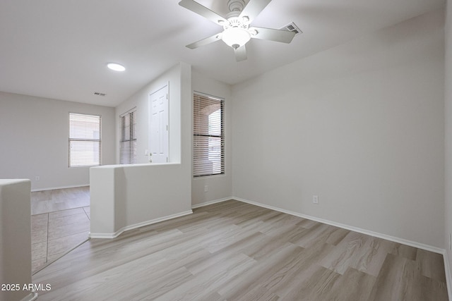 45633 W Mountain View Rd, Maricopa, AZ 85139 - spare room featuring visible vents, a ceiling fan, light wood-style flooring, and baseboards