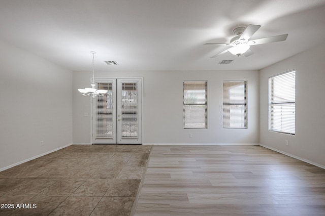 45633 W Mountain View Rd, Maricopa, AZ 85139 - spare room featuring baseboards, visible vents, light tile patterned floors, and ceiling fan with notable chandelier