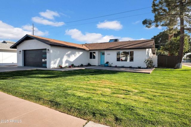 ranch-style home featuring a front lawn and a garage