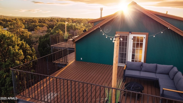 exterior space with french doors, outdoor lounge area, and a view of trees