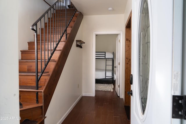 interior space featuring baseboards and wood finished floors