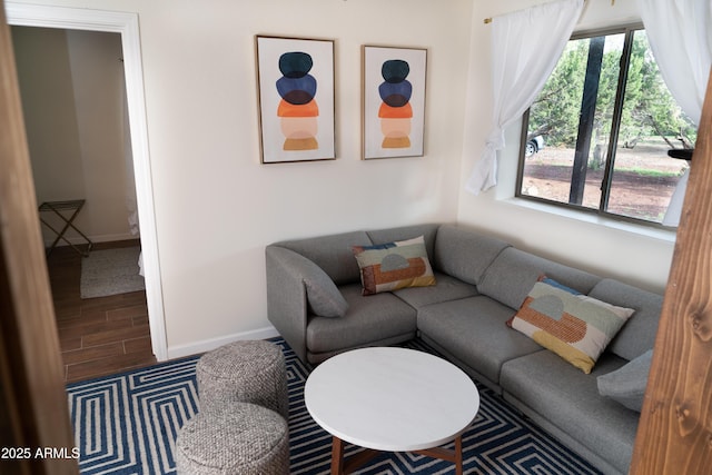 living area featuring wood tiled floor and baseboards