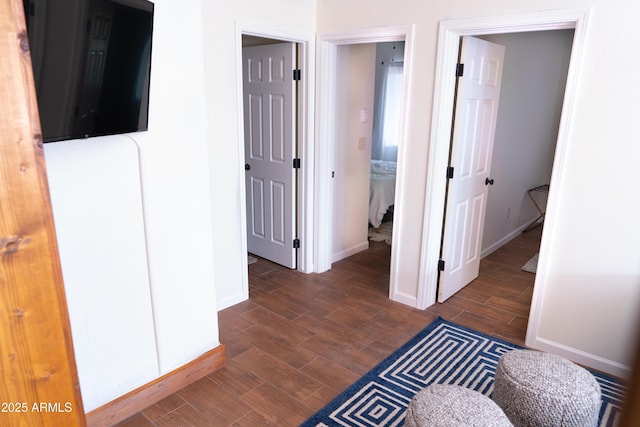 hall featuring wood finish floors and baseboards