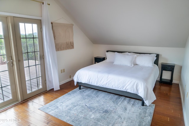 bedroom with access to outside, lofted ceiling, baseboards, and wood finished floors