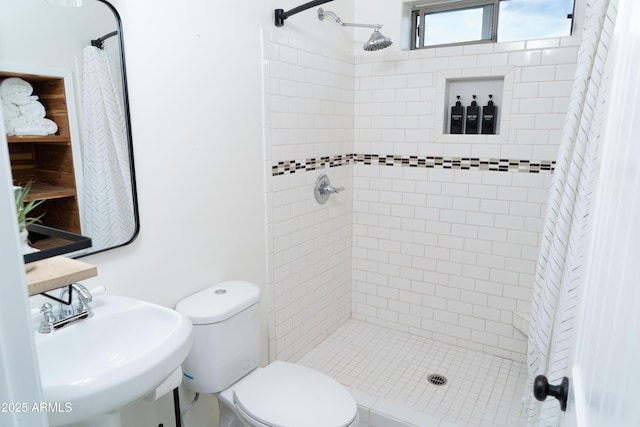 full bath with a stall shower, a sink, and toilet