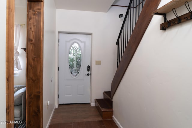 entryway with baseboards, stairway, and dark wood-style flooring