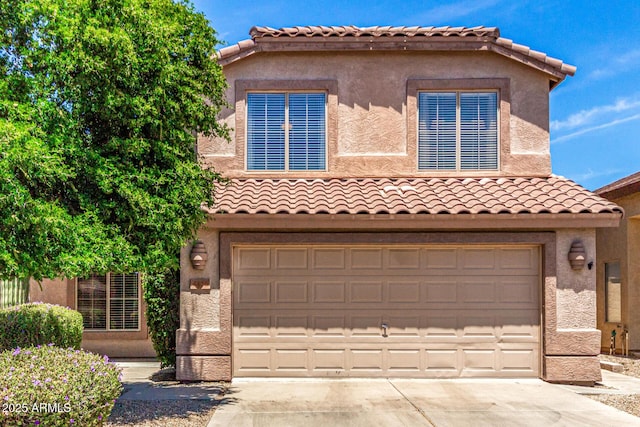 4426 E Coyote Wash Dr, Cave Creek, AZ 85331 - mediterranean / spanish home with driveway, an attached garage, a tile roof, and stucco siding