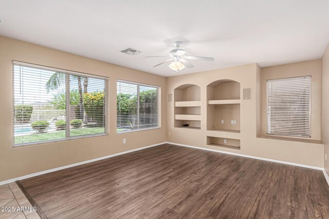 4426 E Coyote Wash Dr, Cave Creek, AZ 85331 - unfurnished room featuring built in shelves, baseboards, and a ceiling fan