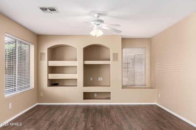 4426 E Coyote Wash Dr, Cave Creek, AZ 85331 - unfurnished living room featuring wood finished floors, built in shelves, ceiling fan, and baseboards