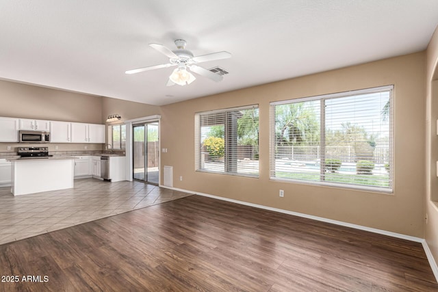 4426 E Coyote Wash Dr, Cave Creek, AZ 85331 - unfurnished living room with baseboards, a sink, ceiling fan, and wood finished floors