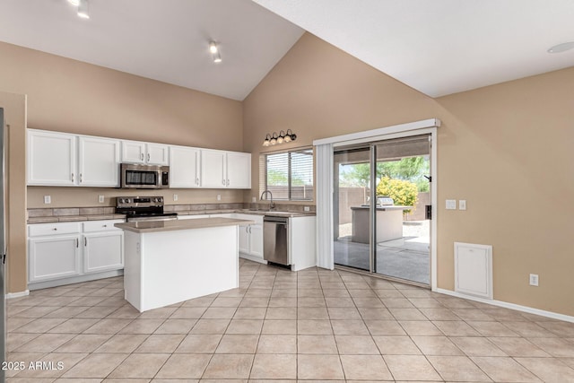 4426 E Coyote Wash Dr, Cave Creek, AZ 85331 - kitchen featuring appliances with stainless steel finishes, high vaulted ceiling, white cabinets, light tile patterned floors, and light countertops