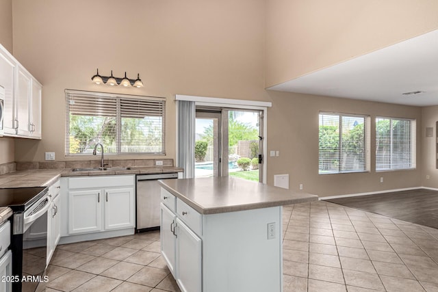 4426 E Coyote Wash Dr, Cave Creek, AZ 85331 - kitchen with stainless steel appliances, a sink, a high ceiling, light tile patterned floors, and open floor plan
