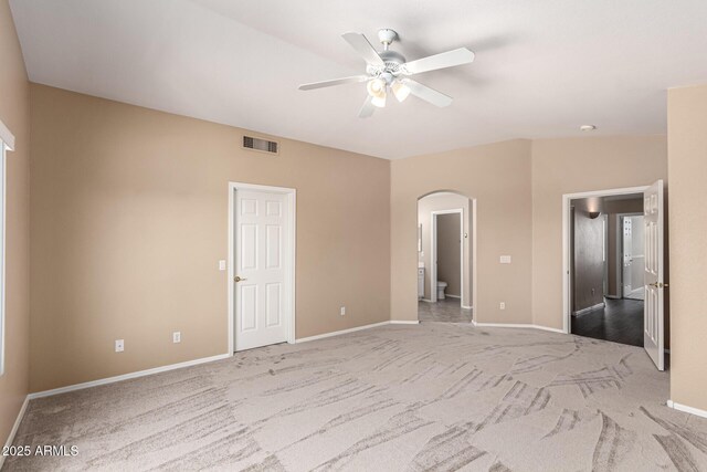 4426 E Coyote Wash Dr, Cave Creek, AZ 85331 - unfurnished bedroom featuring arched walkways, carpet flooring, baseboards, and connected bathroom