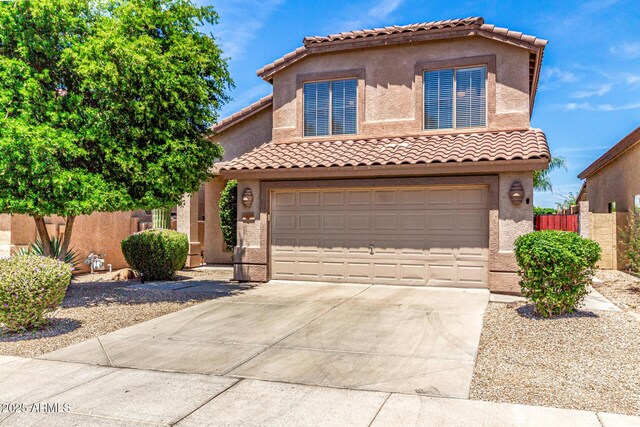 4426 E Coyote Wash Dr, Cave Creek, AZ 85331 - mediterranean / spanish-style home with concrete driveway, an attached garage, stucco siding, and a tile roof