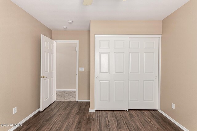 4426 E Coyote Wash Dr, Cave Creek, AZ 85331 - unfurnished bedroom featuring dark wood-style floors, baseboards, and a closet