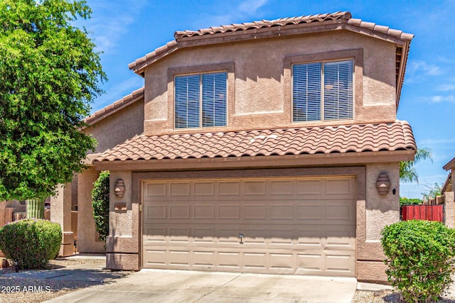 4426 E Coyote Wash Dr, Cave Creek, AZ 85331 - mediterranean / spanish-style home featuring a garage, concrete driveway, a tile roof, and stucco siding