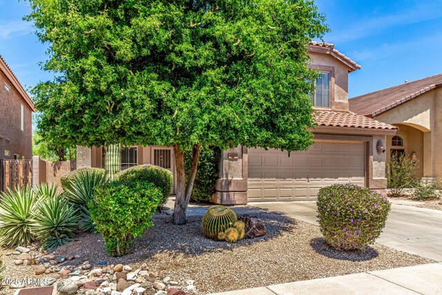 4426 E Coyote Wash Dr, Cave Creek, AZ 85331 - view of property hidden behind natural elements with driveway, a tiled roof, stucco siding, and a garage