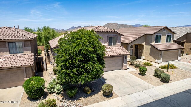 4426 E Coyote Wash Dr, Cave Creek, AZ 85331 - mediterranean / spanish house with stucco siding, driveway, a tiled roof, and a mountain view